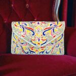 Colorful floral embroidery and silver beadwork clutch bag.