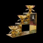Side profile view of 3 step brass diya
