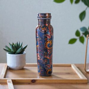 Artisan-made pure copper water bottle from India, shown on a wooden table.
