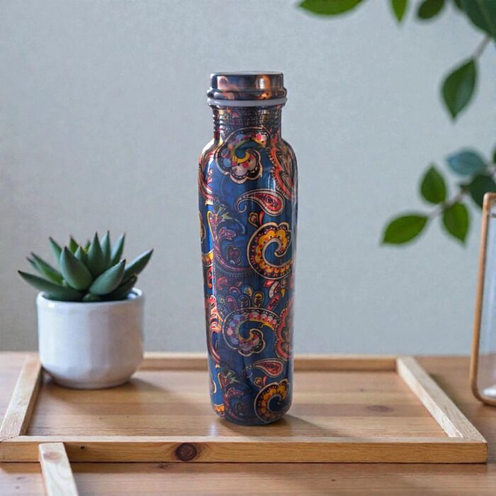 Artisan-made pure copper water bottle from India, shown on a wooden table.