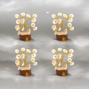 Set of four small Tree of Life decorations with natural spiral Gomti Chakra stones on brass stems and wooden bases.