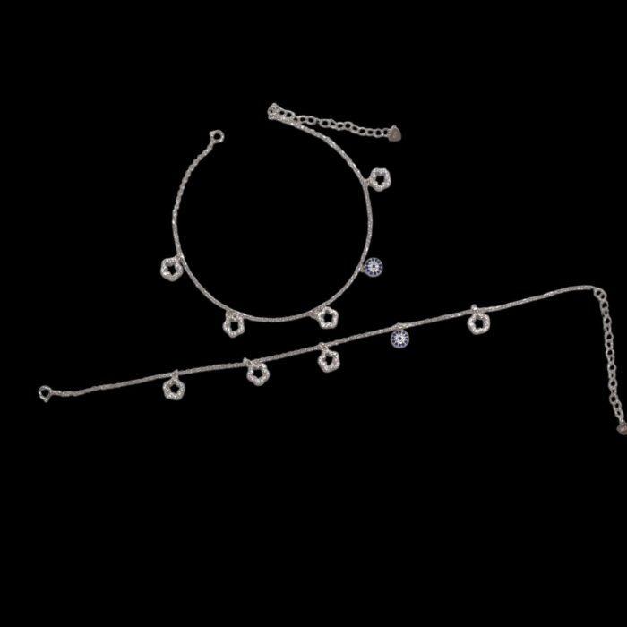 Pair of 925 sterling silver with charms and rhodium finish placed on black velvet screen