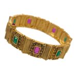 Side view of Matt gold Indian cuff bracelet with larger emerald and ruby stones